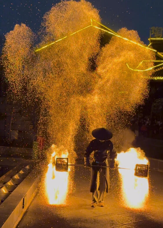 Fire kettle juggling performance